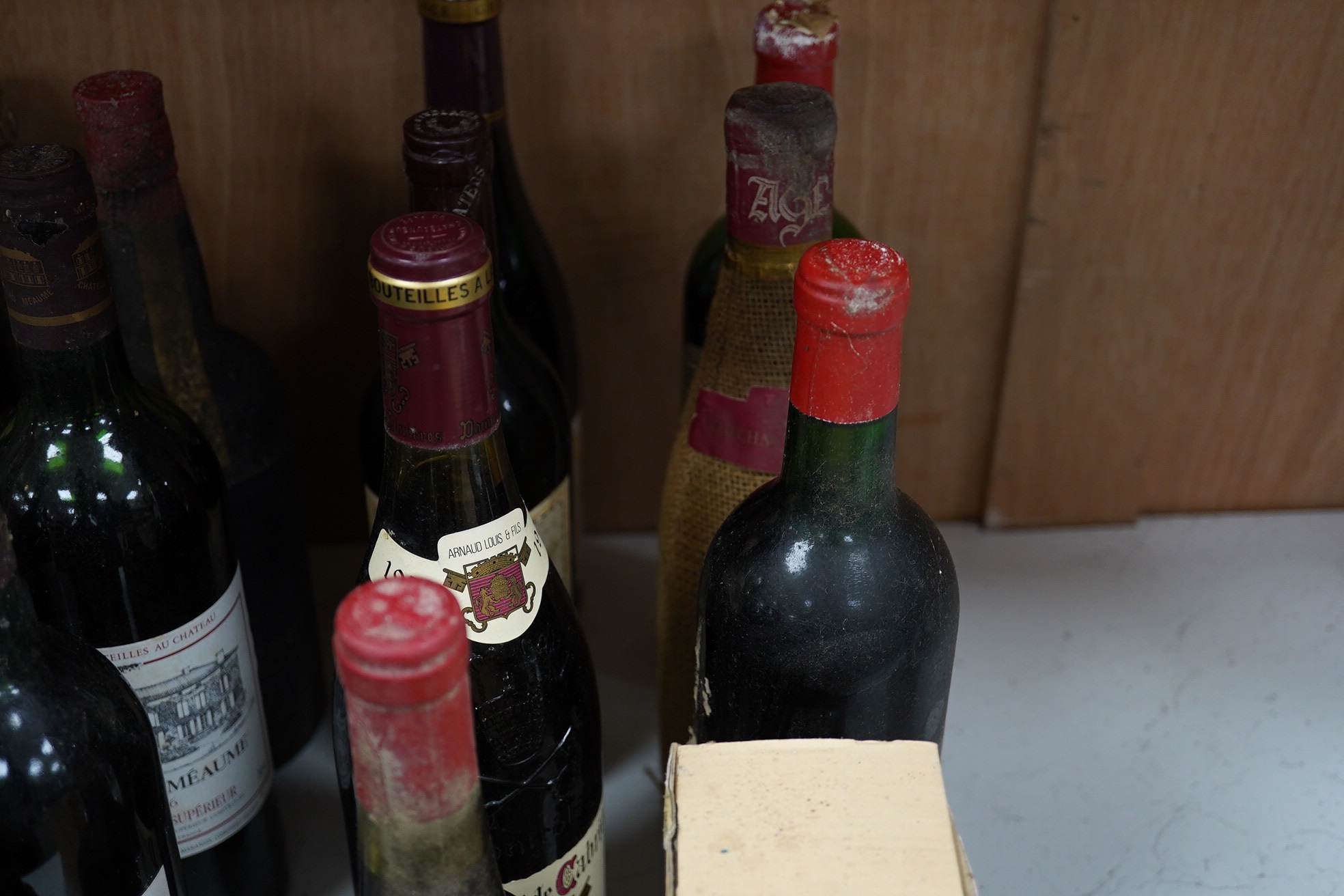 Twenty-five bottles and half bottles of wine, including; four bottles of Chateau Meaume 1986 Bordeaux Superior, a bottle of 1982 Chateau Montbrun Margaux, a Harveys Bourgogne Aligote 1970, etc. Condition - poor to fair